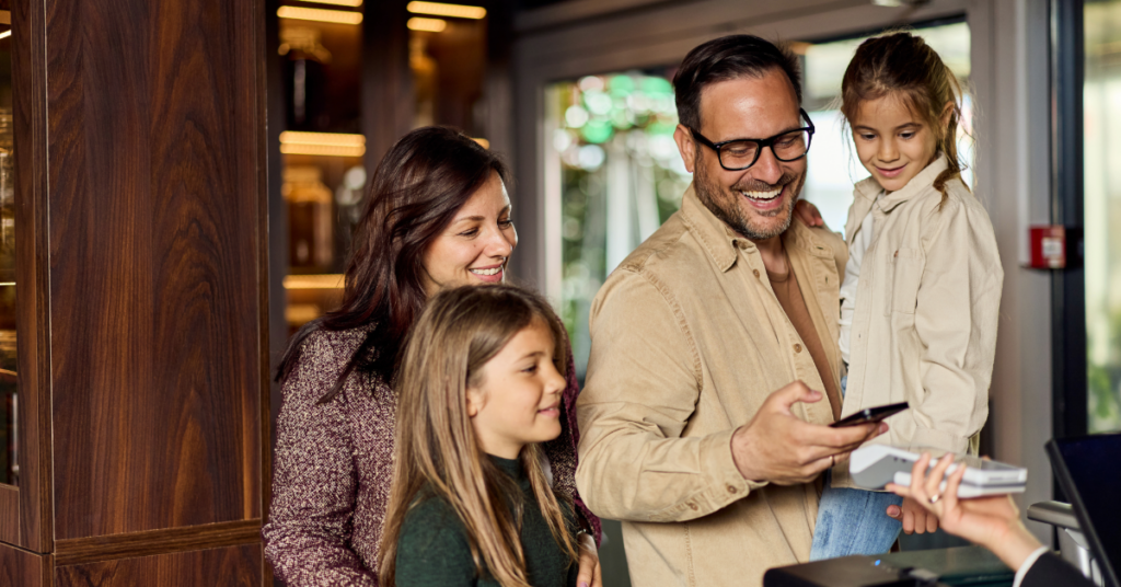Family paying restaurant bill digitally